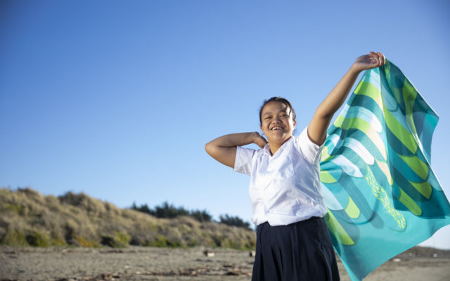 Girl on beach with flag