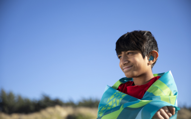 Boy with hearing aids smiling