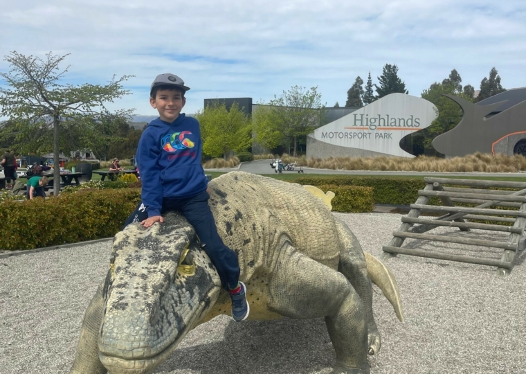 Travis rides a dinosaur